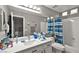 Bathroom featuring a vanity, toilet, bathtub, and shower with blue striped curtain at 2250 Tedesca Dr, Henderson, NV 89052