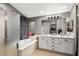 Bathroom with tub, shower, and double sink vanity with great lighting at 2250 Tedesca Dr, Henderson, NV 89052