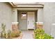 Charming front entrance with stone accents, a white front door, and well-maintained landscaping at 2250 Tedesca Dr, Henderson, NV 89052