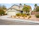 Two-story home featuring a well-manicured front yard with decorative bushes and shrubs at 2250 Tedesca Dr, Henderson, NV 89052