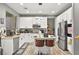 Bright kitchen features white cabinets, stainless steel appliances, a stylish island, and hardwood floors at 2250 Tedesca Dr, Henderson, NV 89052