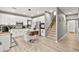 The kitchen features white cabinets, stainless steel appliances, an island with seating, and adjacent staircase at 2250 Tedesca Dr, Henderson, NV 89052