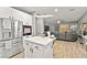 The kitchen and living room are open to one another and feature hardwood floors and stainless steel appliances at 2250 Tedesca Dr, Henderson, NV 89052