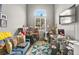 The office features an arched window, blue sofa, and a work space at 2250 Tedesca Dr, Henderson, NV 89052