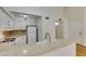 A well lit kitchen featuring a gas stove and oven, white cabinets and wooden floors at 2251 Wigwam Pkwy # 824, Henderson, NV 89074