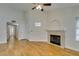 Bright living room with a fireplace, ceiling fan, and wood floors for a cozy atmosphere at 2251 Wigwam Pkwy # 824, Henderson, NV 89074