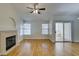 Open living room with fireplace, light hardwood floors, and sliding doors to the outside at 2251 Wigwam Pkwy # 824, Henderson, NV 89074