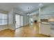 Living room featuring hardwood floors, sliding glass doors to patio, and mirrored wall at 2251 Wigwam Pkwy # 824, Henderson, NV 89074