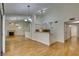 Open-concept living and kitchen area with wood floors and view of the fireplace at 2251 Wigwam Pkwy # 824, Henderson, NV 89074