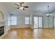 Living room boasts hardwood floors, fireplace, ceiling fan and sliding glass doors at 2251 Wigwam Pkwy # 824, Henderson, NV 89074