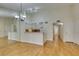 View of the open concept living room with view to the kitchen, and wood floors at 2251 Wigwam Pkwy # 824, Henderson, NV 89074