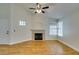 Spacious living room featuring hardwood floors, fireplace, and a ceiling fan at 2251 Wigwam Pkwy # 824, Henderson, NV 89074