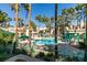 Community swimming pool surrounded by palm trees, lounge chairs, and cabana seating at 2251 Wigwam Pkwy # 824, Henderson, NV 89074