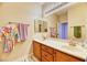 Bright bathroom featuring a double sink vanity with wood cabinets and ample counter space at 2285 Moresca Ave, Henderson, NV 89052