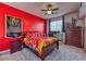 Vibrant bedroom with a dark wood bed, colorful bedding, and décor, creating a lively atmosphere at 2285 Moresca Ave, Henderson, NV 89052