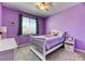 Charming bedroom with soft purple walls and a whimsical decor, perfect for a young dreamer at 2285 Moresca Ave, Henderson, NV 89052