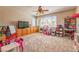 Spacious bedroom with built-in cabinets, a ceiling fan, and a large window overlooking the yard at 2285 Moresca Ave, Henderson, NV 89052