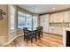 Bright dining area with a wooden table, modern light fixture, and backyard pool view at 2285 Moresca Ave, Henderson, NV 89052