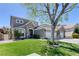 Charming home features a well-manicured lawn, mature tree, and attractive stone accents at 2285 Moresca Ave, Henderson, NV 89052