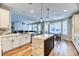 Open-concept kitchen with large island, stainless steel appliances, and wood flooring at 2285 Moresca Ave, Henderson, NV 89052