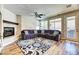 Spacious living room with a fireplace, plush sofa, and access to the backyard at 2285 Moresca Ave, Henderson, NV 89052