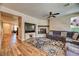 Open concept living room with a fireplace, TV, and hardwood floors at 2285 Moresca Ave, Henderson, NV 89052