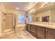 Well-lit main bathroom features a walk-in shower, soaking tub, double sinks, and a closet at 2285 Moresca Ave, Henderson, NV 89052