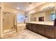 Well-lit main bathroom features a walk-in shower, soaking tub, double sinks, and a closet at 2285 Moresca Ave, Henderson, NV 89052