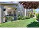 Backyard patio with a built-in grill and lush green lawn at 2285 Moresca Ave, Henderson, NV 89052