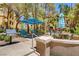 Inviting outdoor community space featuring a grill, lounge chairs, table, and umbrella, perfect for relaxation and entertaining at 230 E Flamingo Rd # 129, Las Vegas, NV 89169