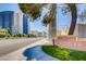 Exterior shot of the Meridian building showcasing lush landscaping and surrounding city buildings at 230 E Flamingo Rd # 129, Las Vegas, NV 89169