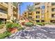 Beautifully landscaped exterior featuring well-maintained grounds, colorful flowers, and mature palm trees at 230 E Flamingo Rd # 129, Las Vegas, NV 89169