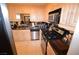 Modern kitchen featuring stainless steel appliances, granite countertops, and wood cabinets at 230 E Flamingo Rd # 129, Las Vegas, NV 89169