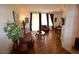 Inviting living room featuring hardwood floors, comfortable seating, and natural light from the windows at 230 E Flamingo Rd # 129, Las Vegas, NV 89169