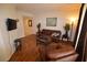 Comfortable living room featuring hardwood floors, a cozy couch, and stylish decor at 230 E Flamingo Rd # 129, Las Vegas, NV 89169