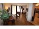 Open living room showcasing wood floors, comfortable leather seating, and natural light from the sliding doors at 230 E Flamingo Rd # 129, Las Vegas, NV 89169