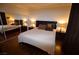 Comfortable main bedroom with plush bedding, dark wood furniture, and a mirrored closet that gives the illusion of extra space at 230 E Flamingo Rd # 129, Las Vegas, NV 89169