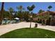 Beautiful pool area with lush landscaping, lounge chairs, and umbrellas, perfect for relaxation and recreation at 230 E Flamingo Rd # 129, Las Vegas, NV 89169