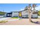 Charming single-story home featuring a vibrant yellow door, xeriscaped landscaping, and covered carport at 237 Cervantes St, Las Vegas, NV 89101