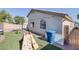 Backyard featuring artificial grass, a play structure, and convenient side yard access at 2410 Morocco Ave, North Las Vegas, NV 89031