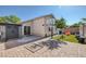 Paver patio and artificial turf enhance the backyard with basketball hoop, shed, and a slide for entertainment at 2410 Morocco Ave, North Las Vegas, NV 89031