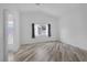 Bright bedroom with wood-look floors and a window with sheer curtains at 2410 Morocco Ave, North Las Vegas, NV 89031