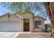 Attractive home with a covered entryway, two-car garage, and desert landscaping at 2410 Morocco Ave, North Las Vegas, NV 89031