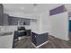 Updated kitchen with stainless steel appliances, island, gray cabinetry and open layout at 2410 Morocco Ave, North Las Vegas, NV 89031