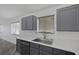 The kitchen features a stainless steel sink, gray cabinets, and white countertops at 2410 Morocco Ave, North Las Vegas, NV 89031
