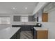 Spacious kitchen with gray cabinets, white countertops, and stainless steel appliances at 2410 Morocco Ave, North Las Vegas, NV 89031