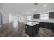 Open floor plan showcasing a kitchen with a center island and stainless steel appliances at 2410 Morocco Ave, North Las Vegas, NV 89031