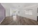 The light-filled living room has sliding glass doors, wood-look floors, and modern design at 2410 Morocco Ave, North Las Vegas, NV 89031