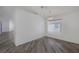 Open living area with stylish wood-look floors, light fixture, and large bright window at 2410 Morocco Ave, North Las Vegas, NV 89031
