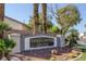 Community sign for Tierra de las Palmas, with palm trees and desert landscaping in a suburban neighborhood at 2410 Morocco Ave, North Las Vegas, NV 89031